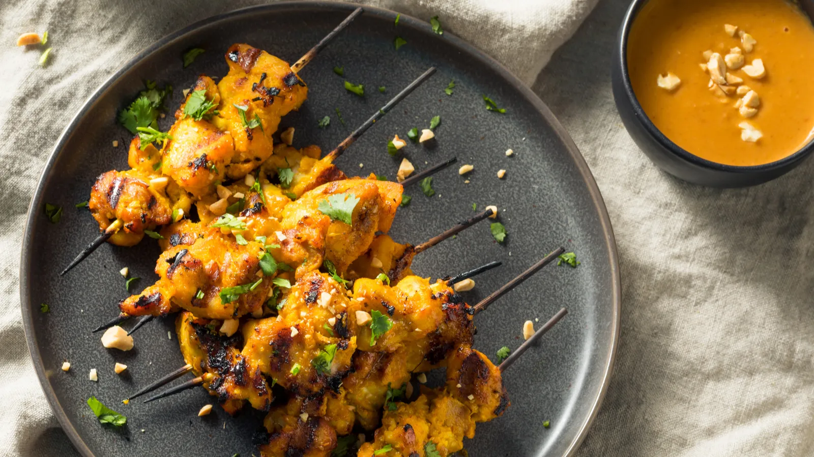 Indonesian chicken satay with peanut sauce is the smoky classic worth grilling